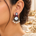 Multicolour oxidized dangle earring with pearl and red accents worn on an ear | SISTERHOODS-SHA256:25e667fe054997c3fd97f2c4310eba4d96456e7764453ee84fe964294fe76db0