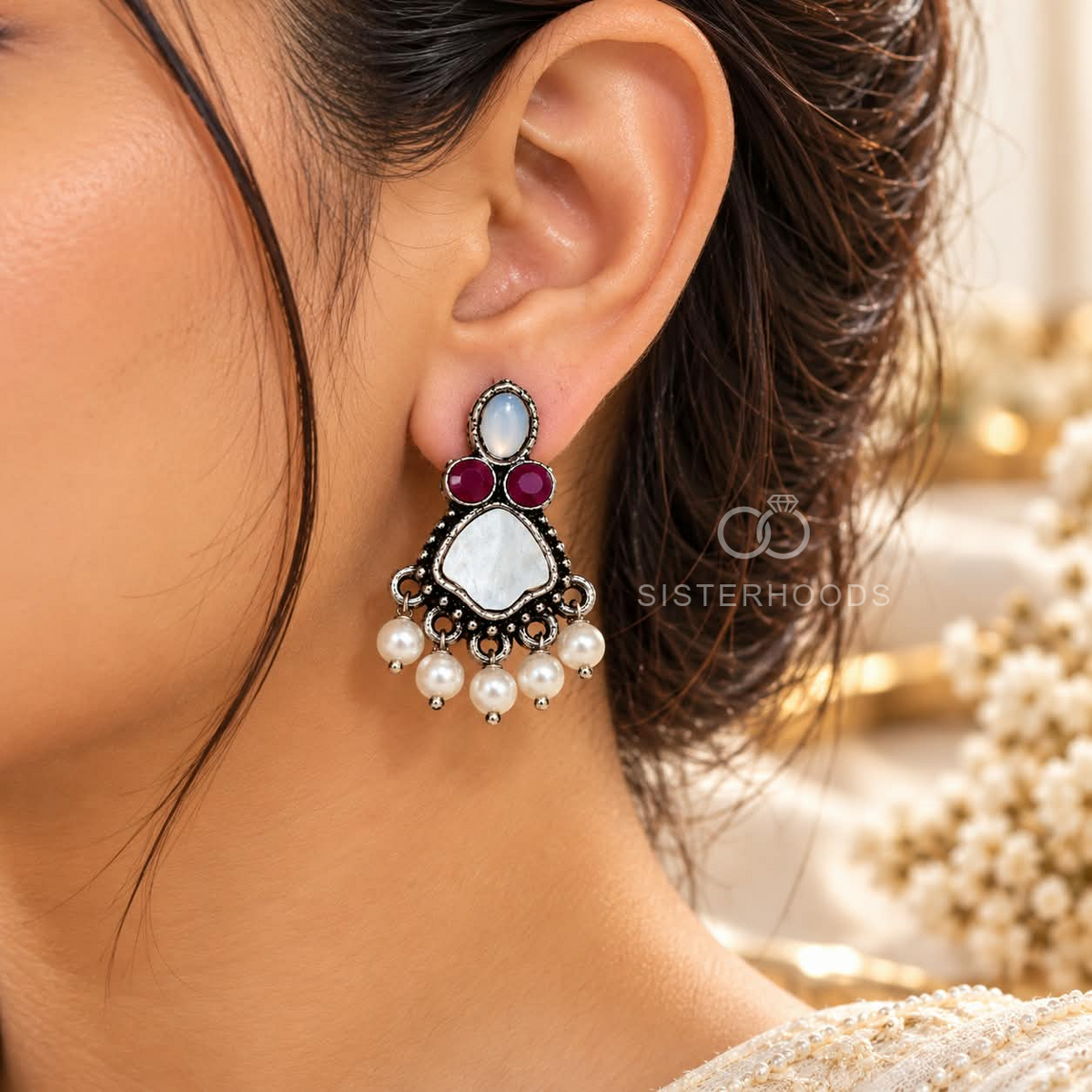 Multicolour oxidized dangle earring with pearl and red accents worn on an ear | SISTERHOODS-SHA256:25e667fe054997c3fd97f2c4310eba4d96456e7764453ee84fe964294fe76db0