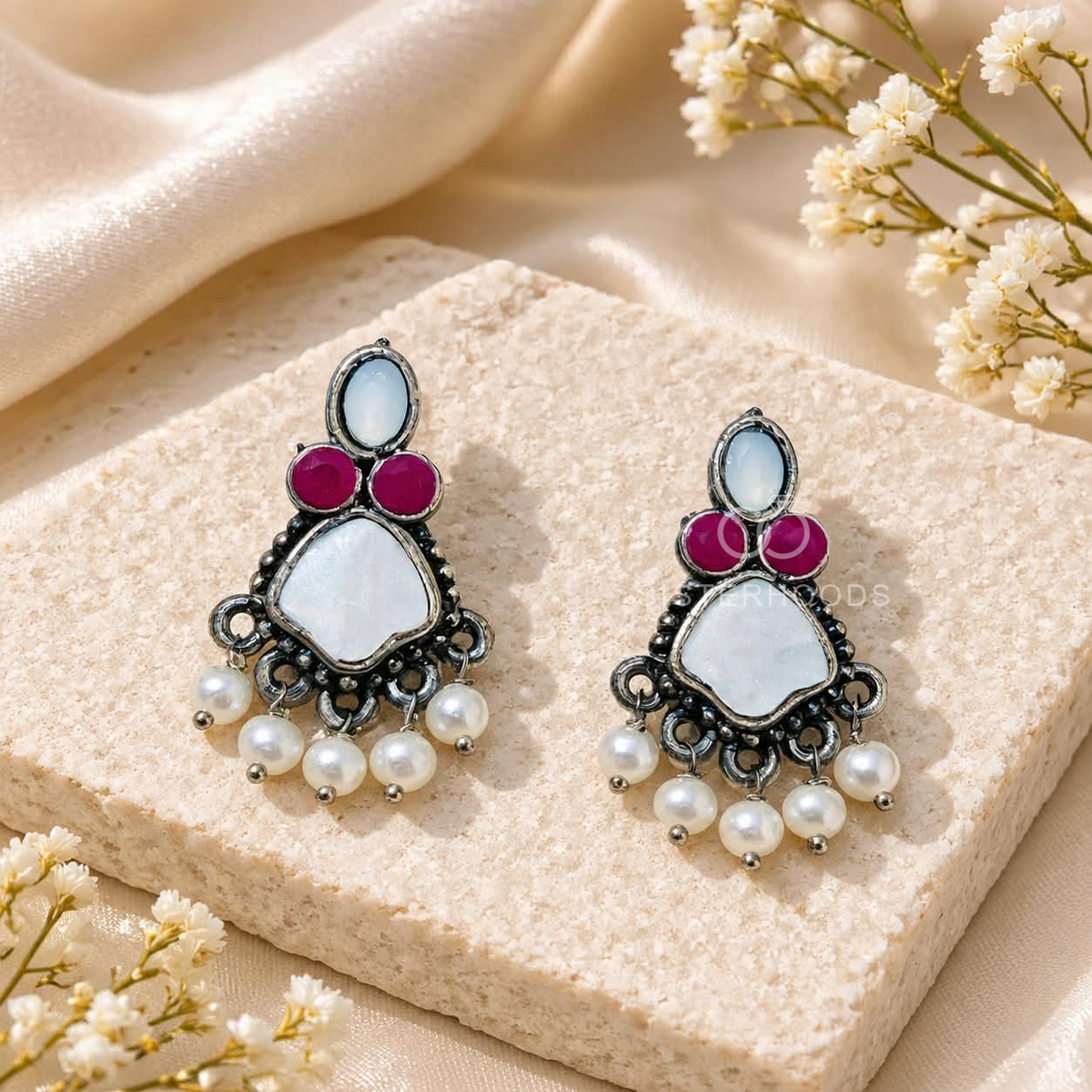 Multicolour oxidized dangle earring with pearl and red accents worn on an ear | SISTERHOODS-SHA256:f6fe4c9d4f1031934d4f70b93c61af13ebe6e9df158994c1a88a4343edb1bda7