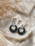 Glossy black circular hoop earrings with silver-tone rectangular tops | SISTERHOODS-SHA256:0f8303164f81720007f5932368bd62ee825af33954e00a9a95d72b6ba90464d1