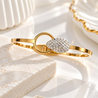 Gold-tone bracelet with crystal-studded oval centre and circular accent | SISTERHOODS-SHA256:e9aac8cda2ec5f9698add3b17e5c8a83efed9d805fcd33b4078227c4d52d10e3