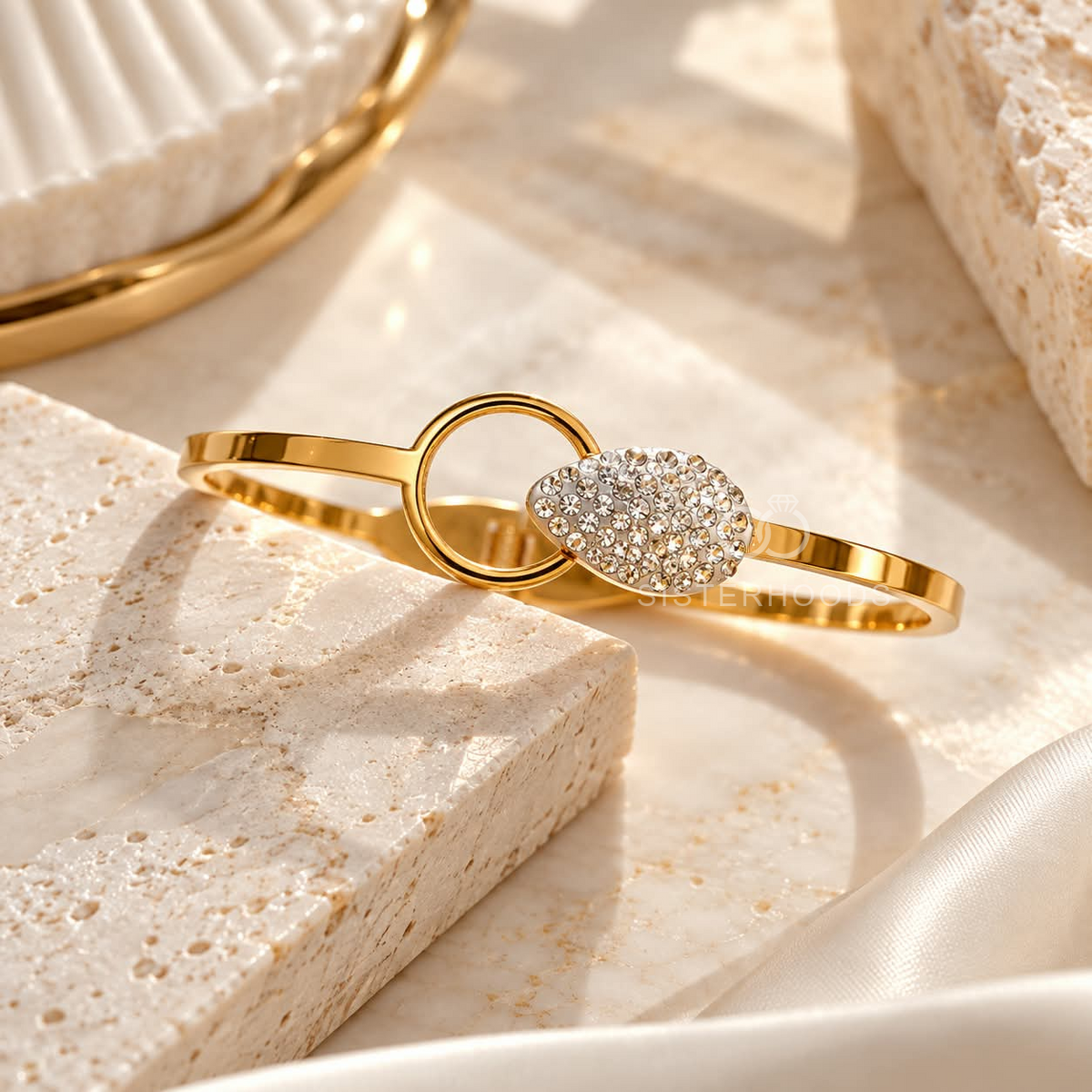 Gold-tone bracelet with crystal-studded oval centre and circular accent | SISTERHOODS-SHA256:46a6d60677dca9052612a89b529773161be677274e557a31bf323e782758e908