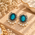 Teal oval oxidized dangle earrings with ornate detailing and white pearl fringe accents | SISTERHOODS-SHA256:d47a20d08f10812d17275b2ea27c8bbd3a5ef24255c89ac69f5d55155249007a