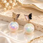 Butterfly stud earrings with black and pink wings and iridescent pearl drops | SISTERHOODS-SHA256:34c16a9b21444aff154b7c250aa6df58a62cc38b38c5b321a2e7678a9ec71819