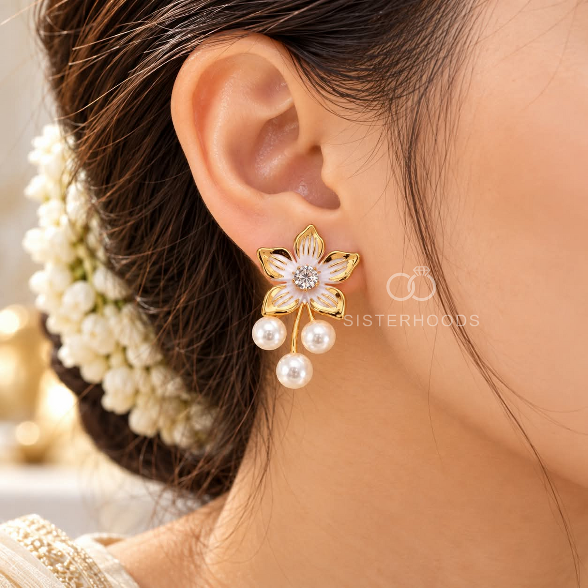 Gold-coloured floral dangle earring with white pearl drops and a sparkling centre accent | SISTERHOODS-SHA256:2596ed012c4d928ee27dfae647d6dfb784d20eed10c3b63ae6543eab2c6c8433