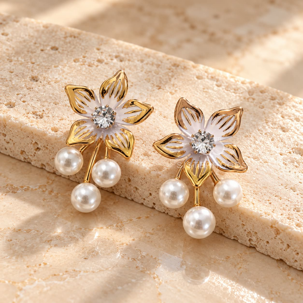 Gold-coloured floral dangle earring with white pearl drops and a sparkling centre accent | SISTERHOODS-SHA256:2dab6395683bcf1c166f2344955f8b6bd99db2fd46757e00cff577e3f6d6bbf8