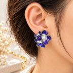 Purple floral stud earrings with white pearl-like centre accents and silver-toned edging | SISTERHOODS-SHA256:440cd21afd37d7498be02e269c37b308822c7cb8e046ecd2e7f5a6cc9a45c8fc