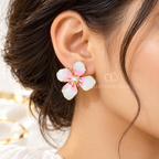Pink and white flower stud earrings with pearl-like centres and gold-tone detailing | SISTERHOODS-SHA256:a4a3e2083a09c8fec0b777de74cdf553c63b132f929da0cdf6f4c40dadd5e1fd