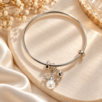 Silver-tone adjustable bracelet with pearl crown charm and sparkling accents | SISTERHOODS-SHA256:e4370bc23aedc9bcccfd4675e32ed3a754922ad134877f93bf699ba356f31f1f