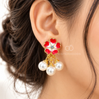Red and white floral drop earrings with pearl beads and gold-coloured detailing. | SISTERHOODS-SHA256:3a7050e8fe143e76900e181f3a45a14c4c25f584122e2efe729208ef9a1a387e