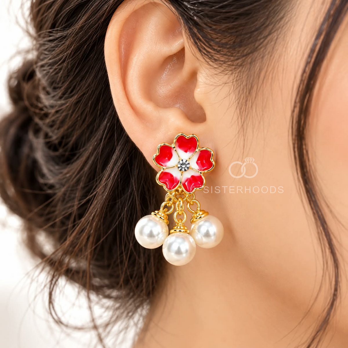 Red and white floral drop earrings with pearl beads and gold-coloured detailing. | SISTERHOODS-SHA256:3a7050e8fe143e76900e181f3a45a14c4c25f584122e2efe729208ef9a1a387e