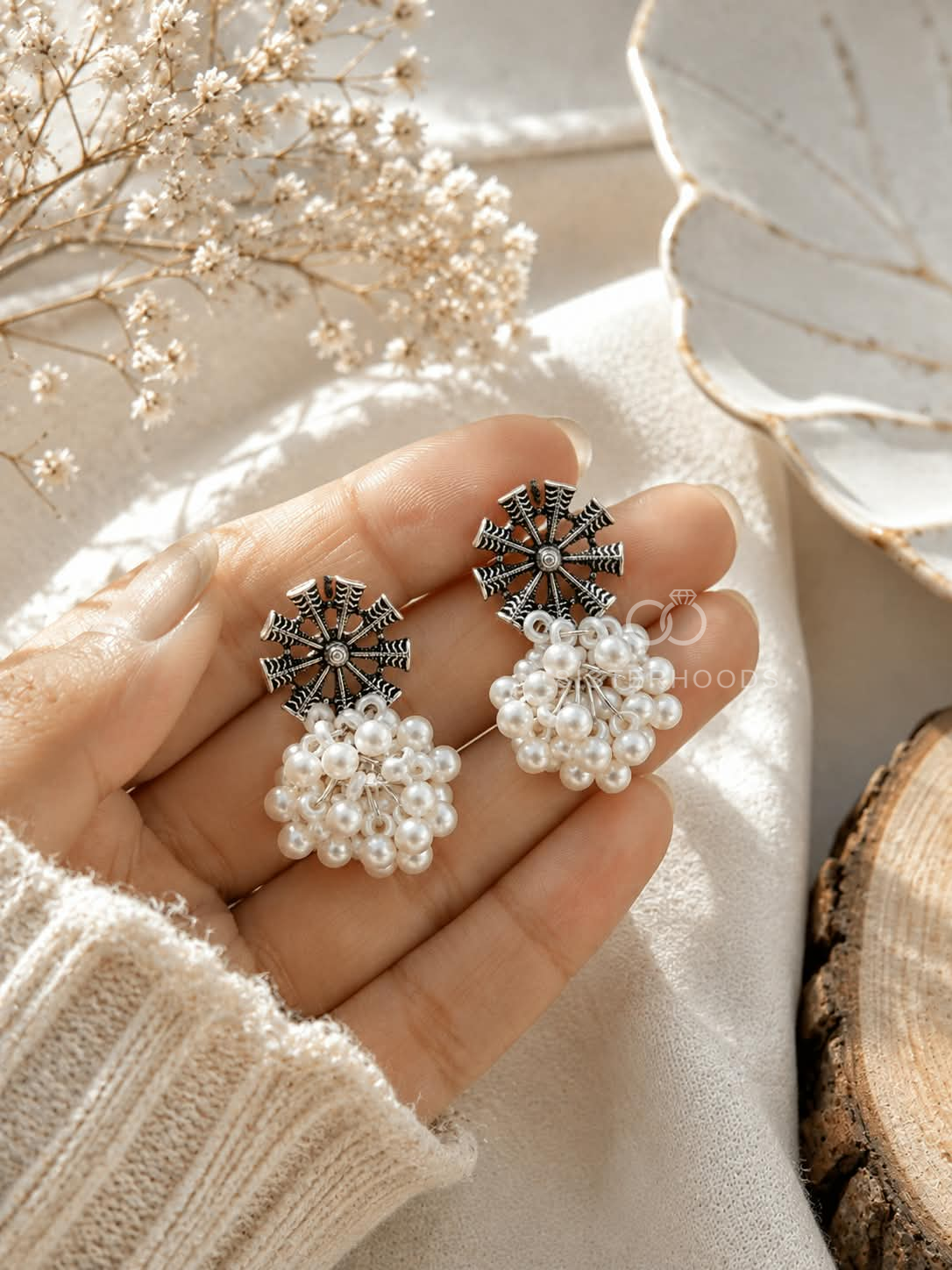 Black and silver spoke earrings with clustered white pearl dangles | SISTERHOODS-SHA256:f09fffac3b9514c31ebf90dc4b02a6f0ff2b8b2ca3820474e824213066469451