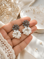 Black and silver spoke earrings with clustered white pearl dangles | SISTERHOODS-SHA256:957834d3a3900d0f655ec0ecb0103b592a4acecfcefcedc4a8495fc9394815cc