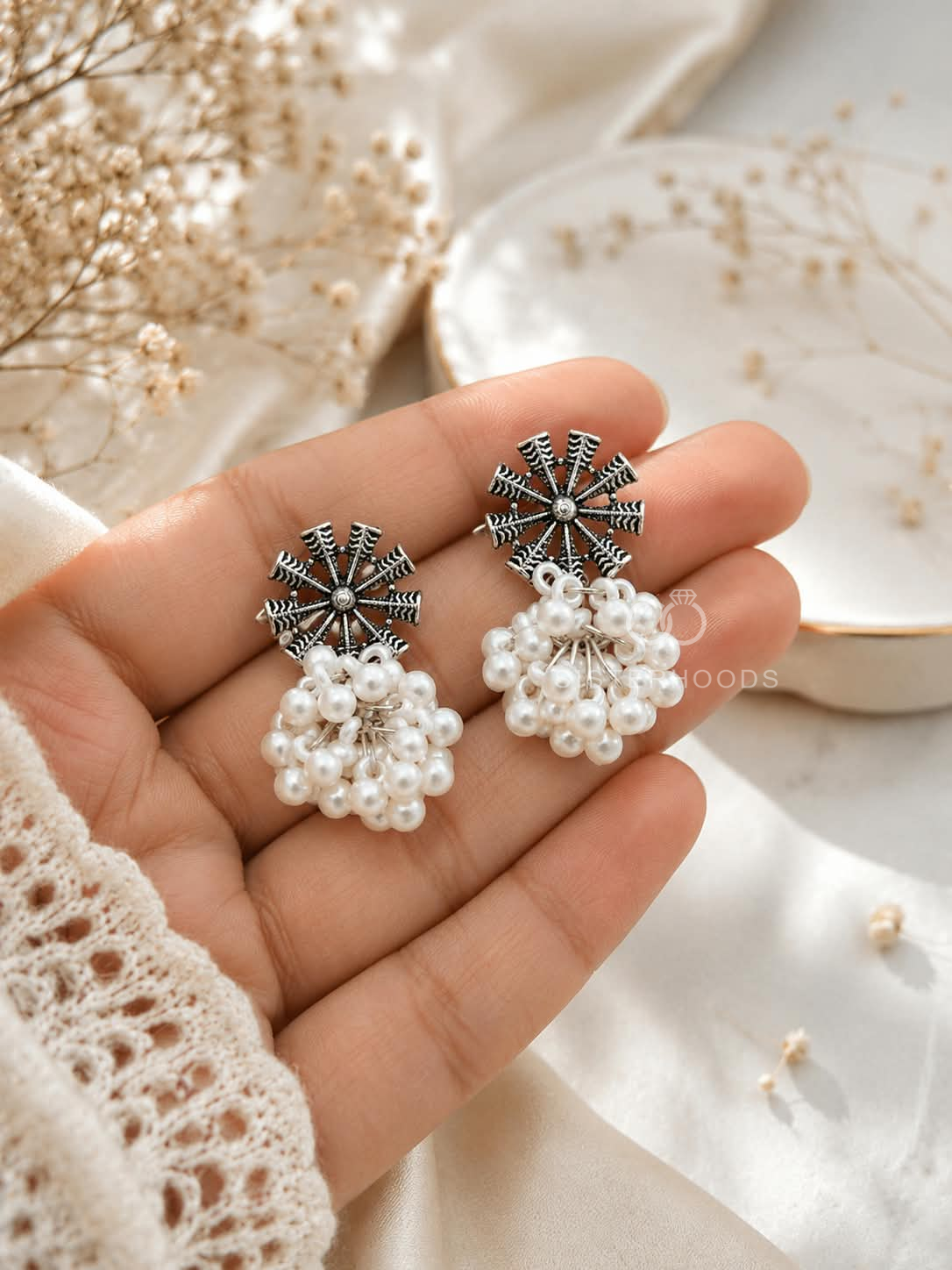 Black and silver spoke earrings with clustered white pearl dangles | SISTERHOODS-SHA256:957834d3a3900d0f655ec0ecb0103b592a4acecfcefcedc4a8495fc9394815cc