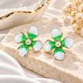 Green and white floral stud earrings with pearl-like centres and gold-tone detailing | SISTERHOODS-SHA256:bbf69bd9236d71c30ad372818ebed0c4e9930bc19af949edb4bb9c4f0ba71401