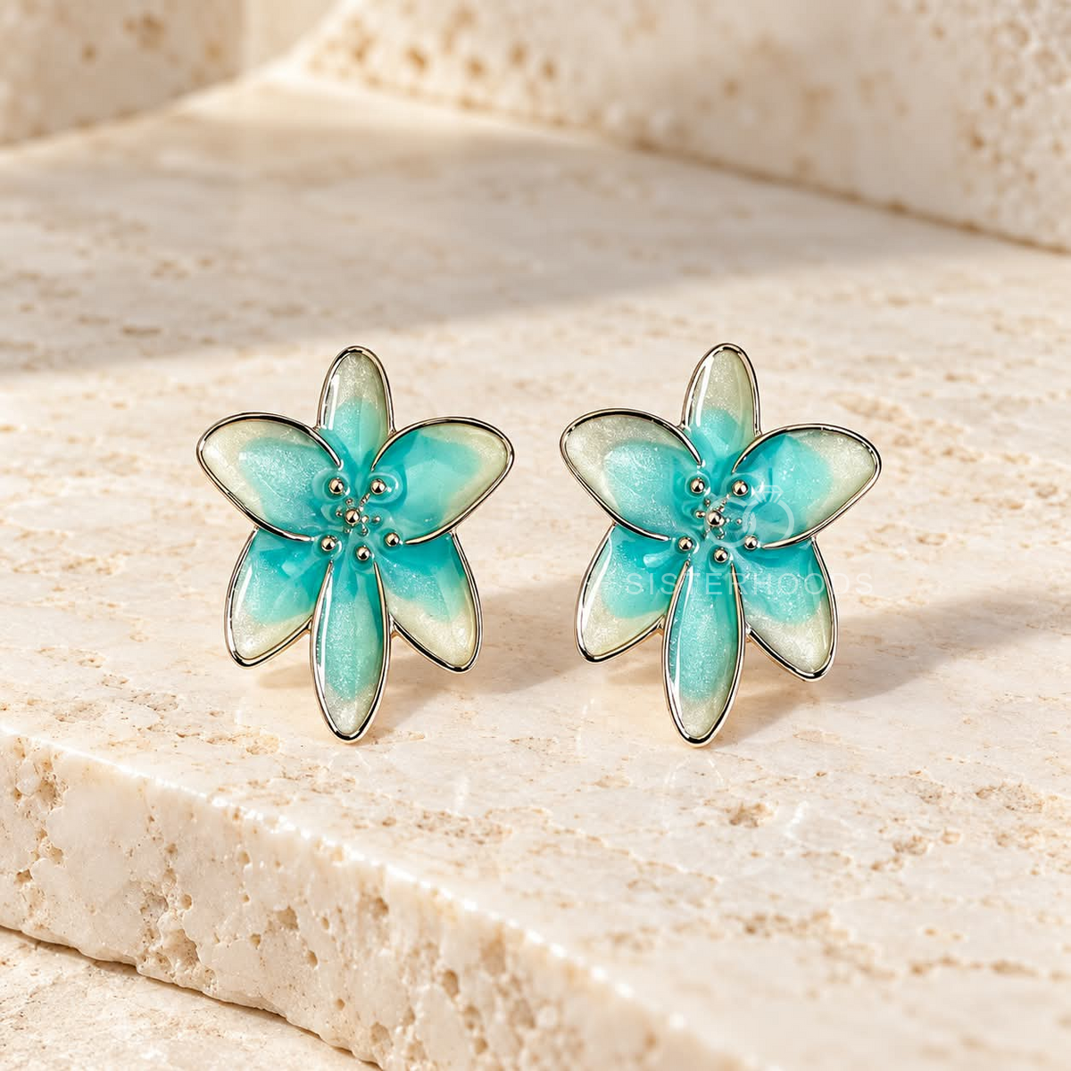 Aqua and cream flower stud earring with gold-tone detailing worn on an ear | SISTERHOODS-SHA256:595fe42076ee54d5df4be66d7e04572bb50de8b0146135ff5b4da39d477a7f59