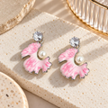Pink floral dangle earrings with pearl accents and round faceted details | SISTERHOODS-SHA256:92cbb3eb277318d41c9cc89901f472035aa7887b38259da8718ef39a56eb77a5