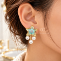 Turquoise floral dangle earrings with a sparkling centre and three white pearl drops | SISTERHOODS-SHA256:a1d26811e3394134fc540c76a65c7917c373bbac20c5506530ca120b994f439d