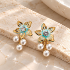 Turquoise floral dangle earrings with a sparkling centre and three white pearl drops | SISTERHOODS-SHA256:dbdb6c32b0171786e92193bf51af2e2a57141672c7c603b55f449ed9b693afa0