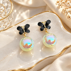 Black butterfly earrings with iridescent round pearl drops | SISTERHOODS-SHA256:93a58e5151952adca6cc9017991332b903672f5ac4137ec0afb4eb0e4f42a88d