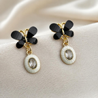 Black floral cluster dangle earrings with white oval accents | SISTERHOODS-SHA256:adc1de899260160c167246b00e18939020af39b74205b3c4d30eba6c2be15d00