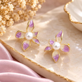 Lavender and cream floral stud earrings with pearl-style centres and gold-tone outlines | SISTERHOODS-SHA256:1649461d19a3162619baeb2236390d808da5eb72b0bf03219be12530dfe97035