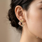 Floral stud earring with blush pink, cream and gold-tone petal details | SISTERHOODS-SHA256:3d1b7f81a1c0d8c74e33758283a8bc496e41074868f4a91cb6a65e833b2f88db