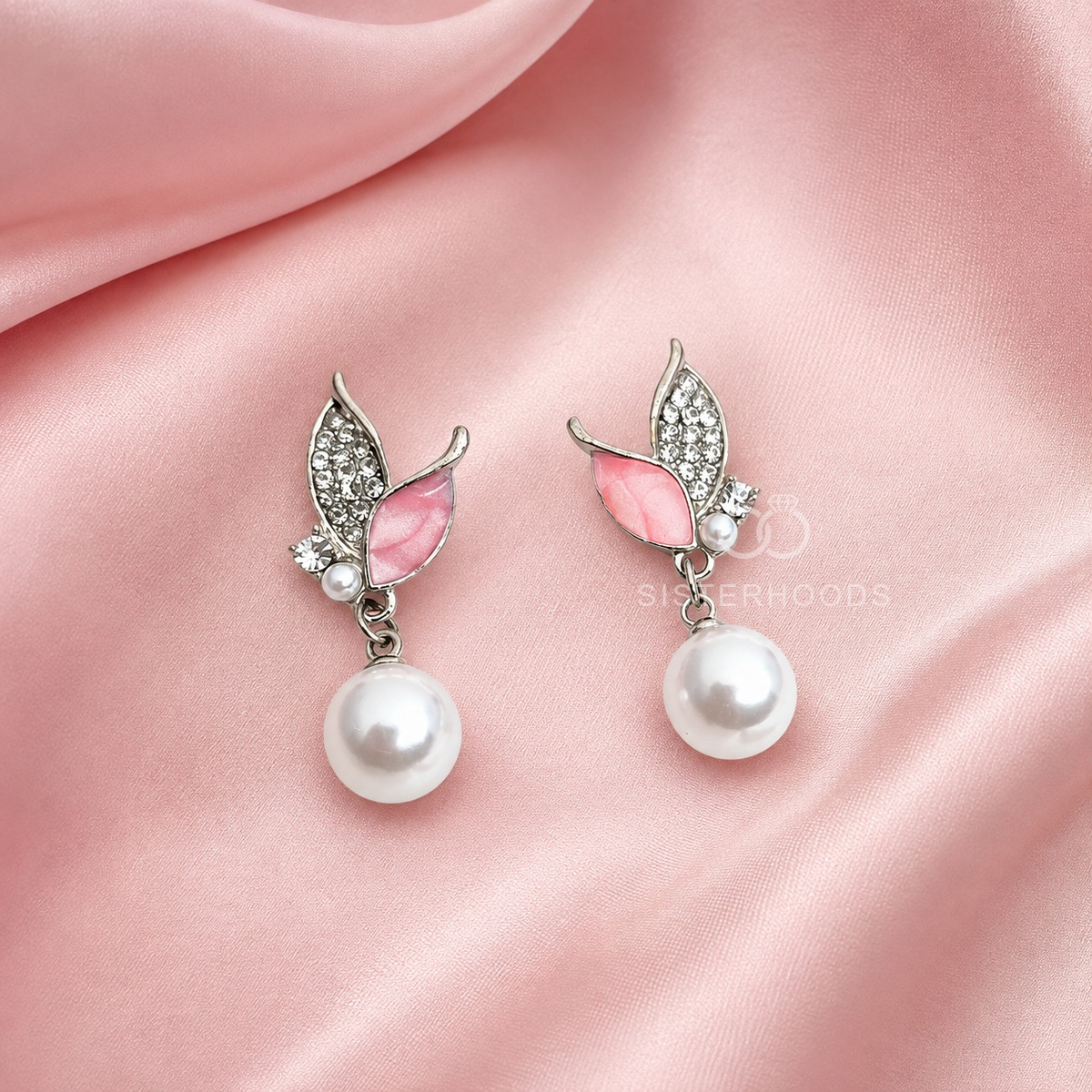 Pink butterfly drop earrings with silver-toned detailing and round white hanging beads | SISTERHOODS-SHA256:9ae8a7a1f8fd9d59e917aad73b1480805a11ef02019bb45b64a22f508f5ee8df