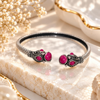 Ornate open cuff bracelet with pink accents and detailed silver-tone motifs | SISTERHOODS-SHA256:7b232590b8ecf523342dadb413ae551269fc3ae58d61b70ef7012acef64d4c20