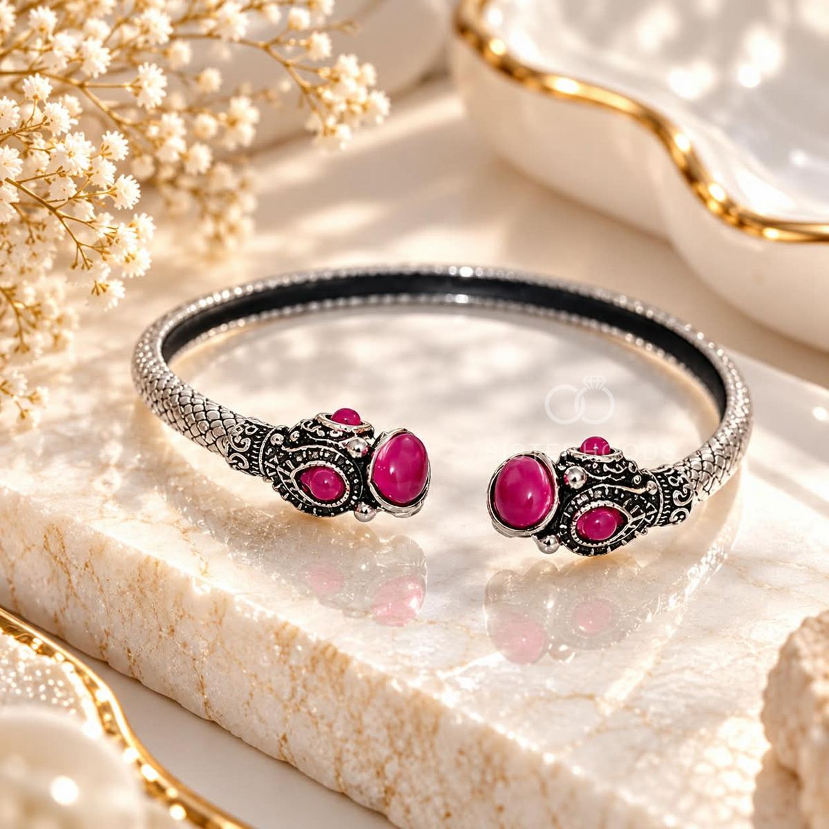 Ornate open cuff bracelet with pink accents and detailed silver-tone motifs | SISTERHOODS-SHA256:7b232590b8ecf523342dadb413ae551269fc3ae58d61b70ef7012acef64d4c20