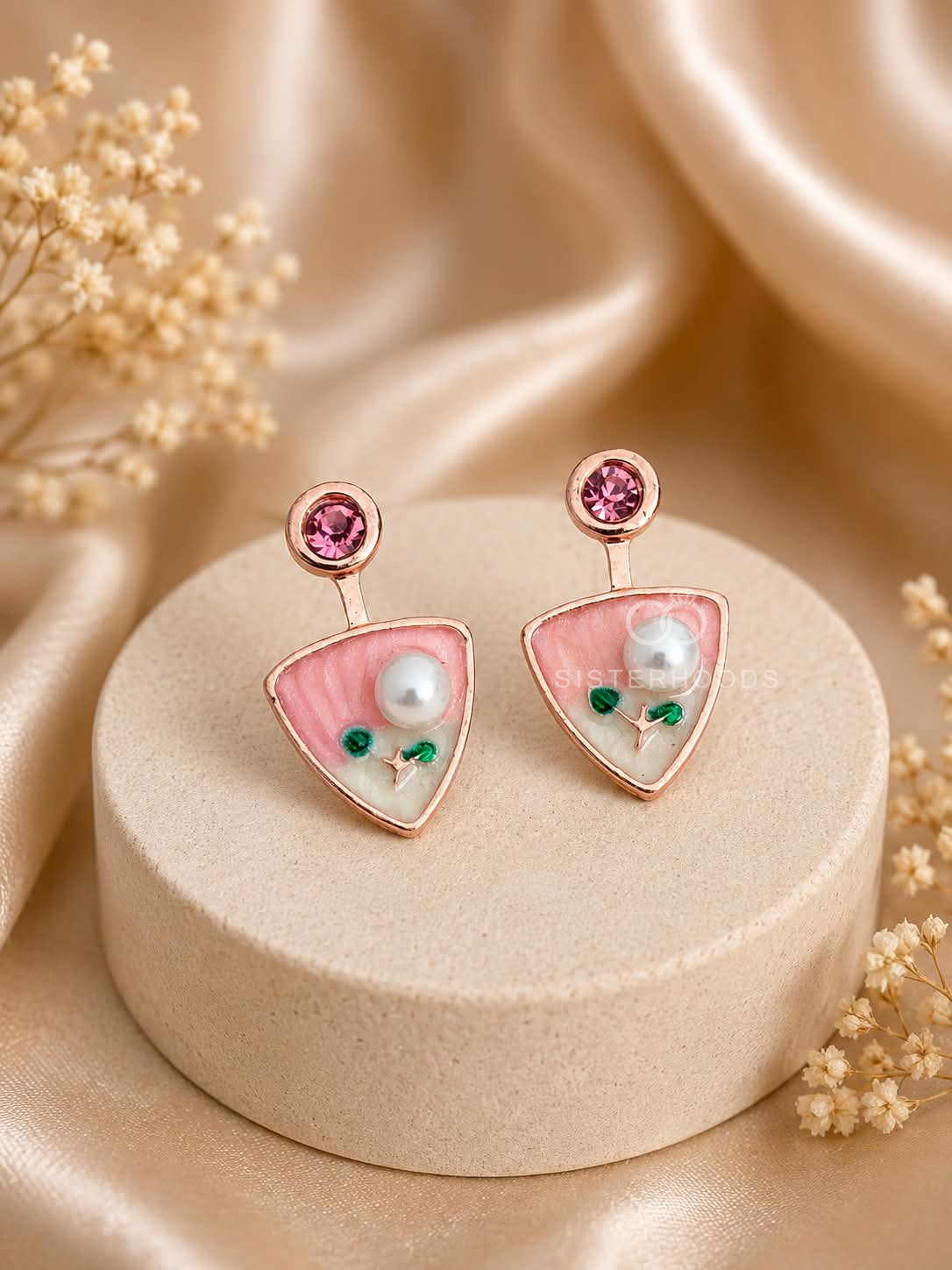 Pink triangular dangle earrings with white bead and green floral accents | SISTERHOODS-SHA256:f930e18fb8306f812be18b1b4125d73f416421a4e616a99926aa7f8f3ff384cb