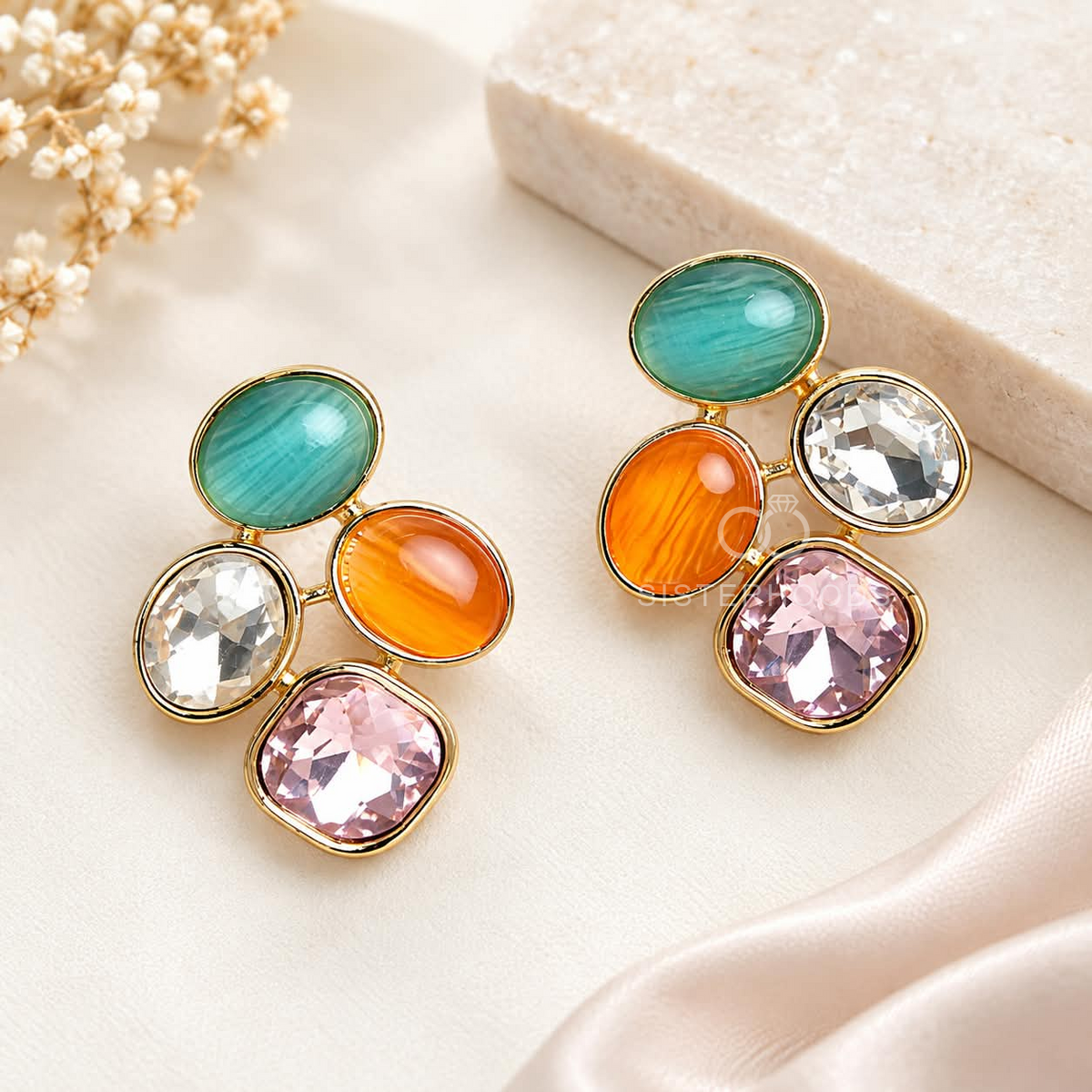 Multicolour cluster stud earrings with teal, orange, clear and pink stones in gold-tone frames | SISTERHOODS-SHA256:76224e80e9d8d73265fdce433df7f14e987b61bc555330189ef1a58e24e0f214