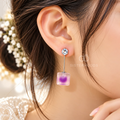 Silver-tone dangle earring with a clear round accent, slim bar and soft purple square drop. | SISTERHOODS-SHA256:ab6929a9bde40caf5926b226666052e3123feb07a4ae2cd1cd9845ea7e9db342