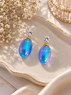 Blue and purple iridescent oval dangle earrings with sparkling round accents | SISTERHOODS-SHA256:508ec82039c8e107e8de1166b4f79d6a4e1d88e306456698079d38540a3099fc