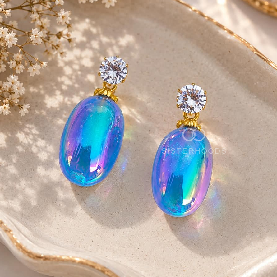 Blue and purple iridescent oval dangle earrings with sparkling round accents | SISTERHOODS-SHA256:df6993bb885731e86c94e60dfbed021e2a72e15d14e0ac6b070a5d93d39298e2