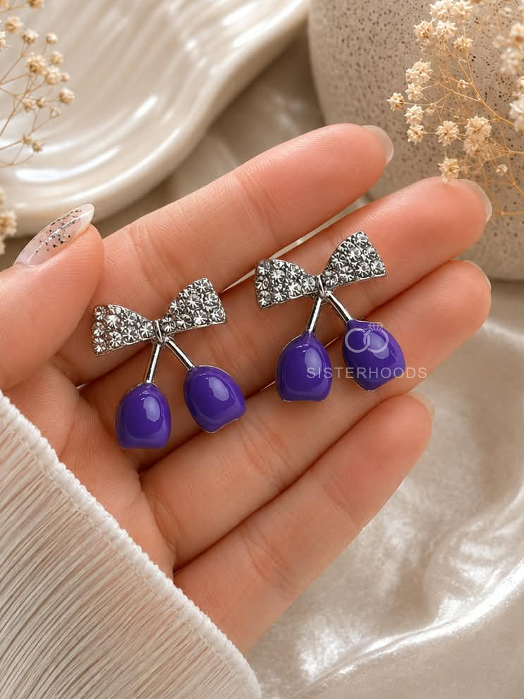 Silver bow earrings with glossy purple cherry-shaped drops | SISTERHOODS-SHA256:0bb335c5031fc0fd9274823e5cacd85b54f85d04597876a50993aee63c6cbd4d