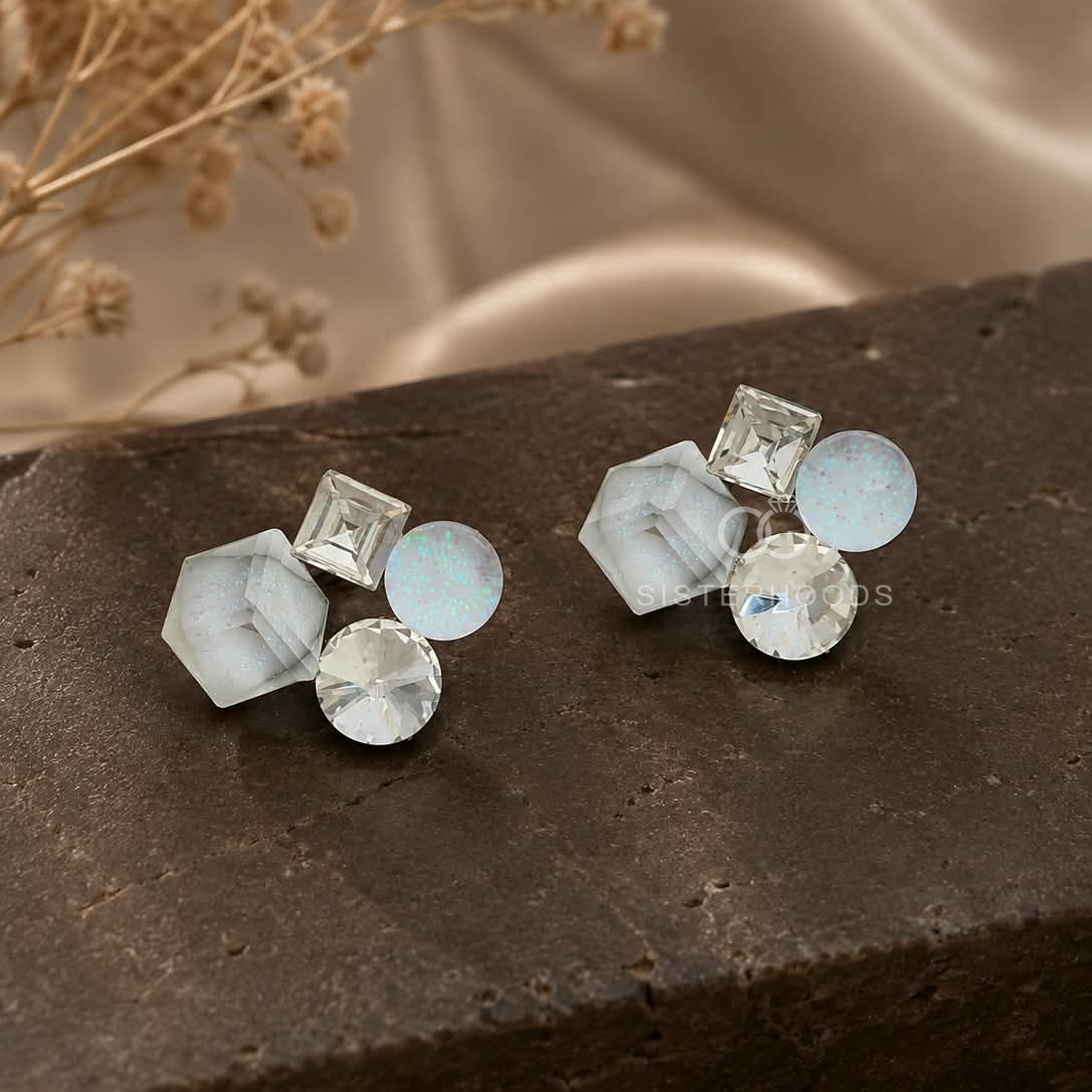 Geometric cluster stud earrings with white, clear and soft blue faceted accents | SISTERHOODS-SHA256:e68b27e7e46356e1302fbbf952239f61a700ab53f10bda3a6b477282ceb96576