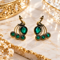 Peacock-inspired dangle earrings with green faceted accents and ornate detailing | SISTERHOODS-SHA256:8aa957ddbe1a55f732480cb50da7994ad580af865e2cb11c0d0602495bc15499