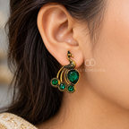 Peacock-inspired dangle earrings with green faceted accents and ornate detailing | SISTERHOODS-SHA256:558a02224e44b0e508e066301969a91a829973e05eb7f202a1d55458bf622657