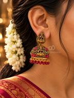 Ornate deity motif jhumka earring with red accents and beaded fringe | SISTERHOODS-SHA256:6d82864a6c07e24fc113f22309561cf76e4be3b68d54458d3c9c5adee362643f