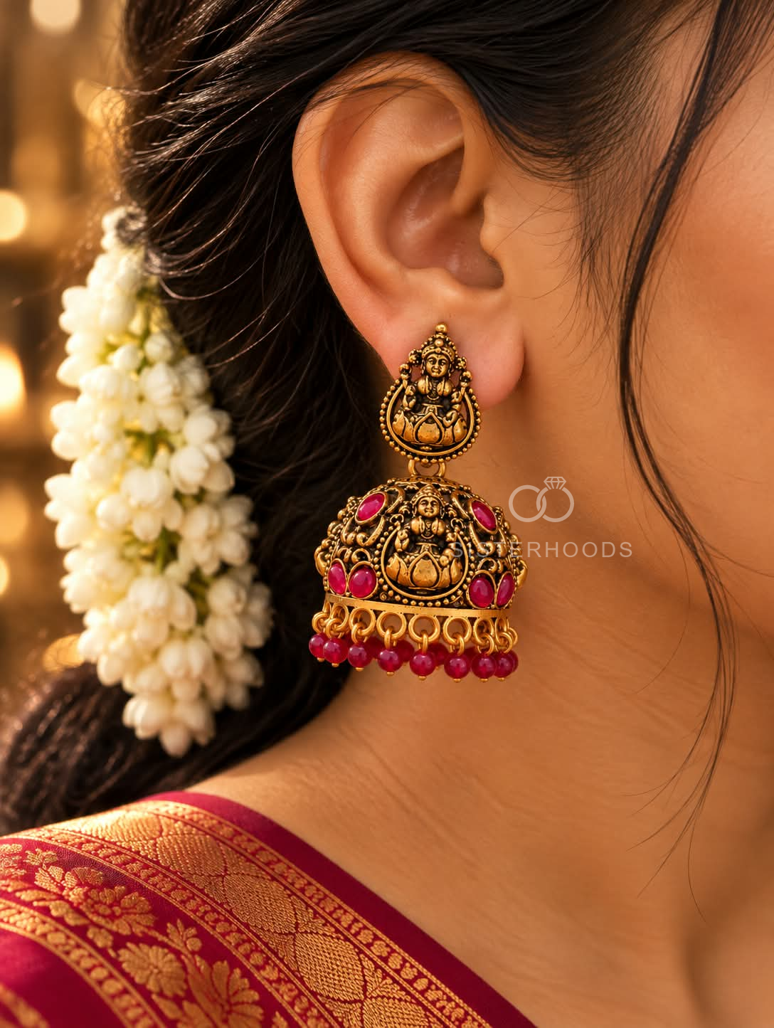 Ornate deity motif jhumka earring with red accents and beaded fringe | SISTERHOODS-SHA256:6d82864a6c07e24fc113f22309561cf76e4be3b68d54458d3c9c5adee362643f