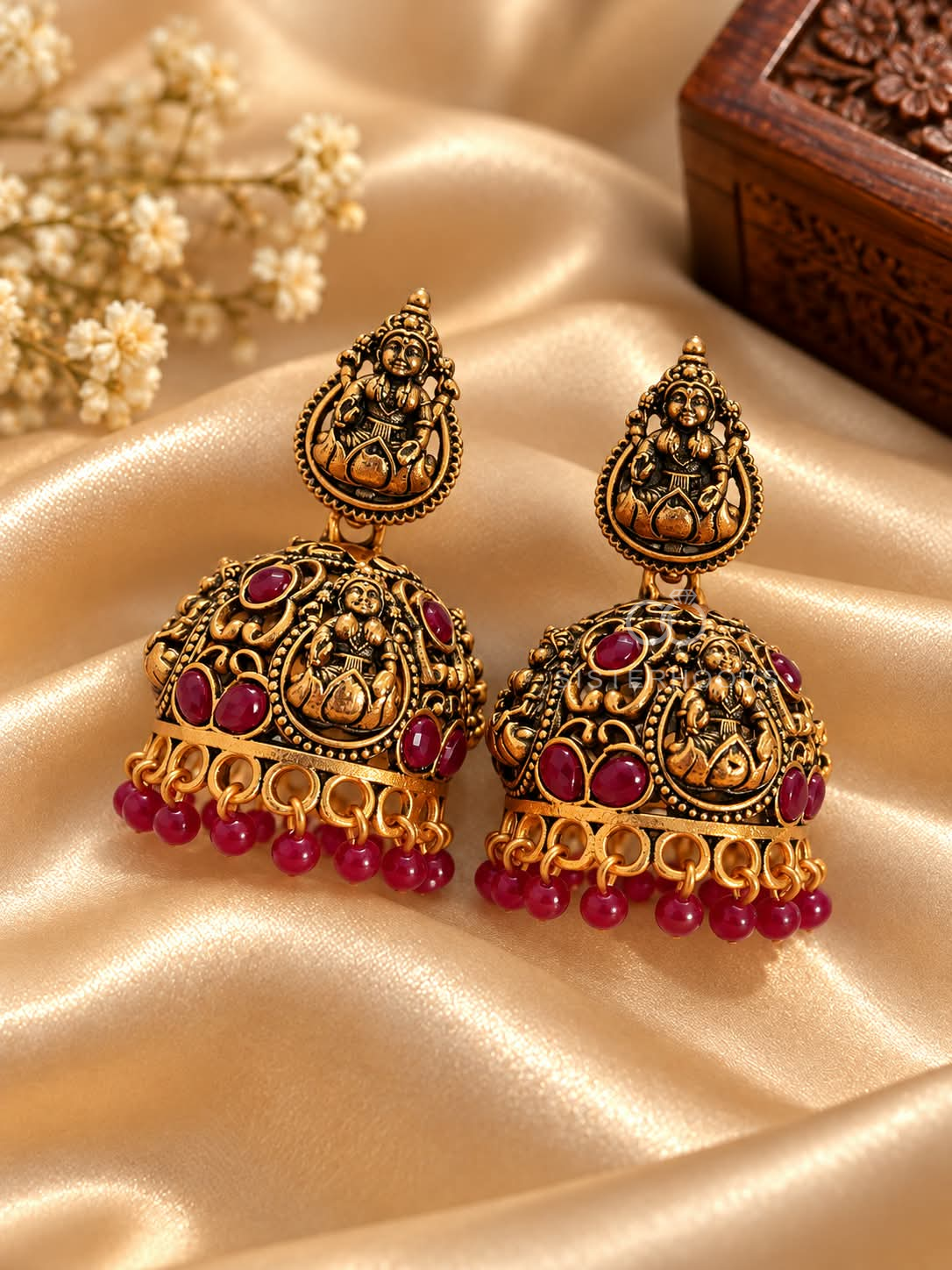 Ornate deity motif jhumka earring with red accents and beaded fringe | SISTERHOODS-SHA256:445df781d0be1078207712c2a0b70b03202036a6fca9dfa42d2811a84ac8556e