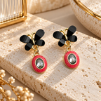 Black wing-shaped earrings with red oval drops and clear faceted centre accents | SISTERHOODS-SHA256:e0f5820f0b1364471f37609e21758bf6be12356b986e688b0ede1f31731b0fcf