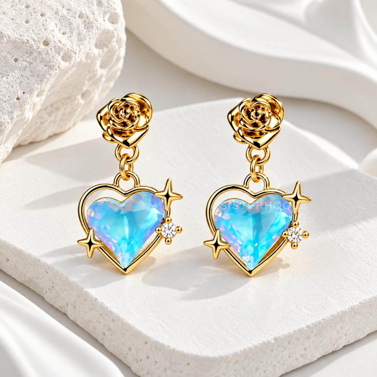 Gold-tone dangle earring with a blue heart charm, rose stud and star accents | SISTERHOODS-SHA256:7f90053eabe59056efd9951229d78afc64163eb07d9dbc6ada414a5b69156242