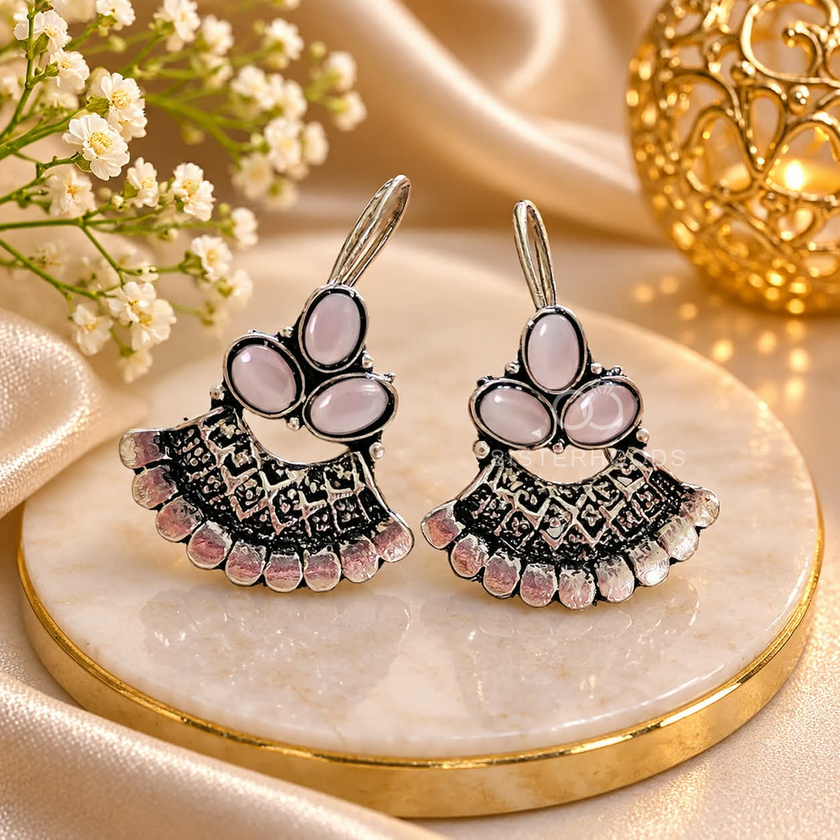 Oxidized silver jhumka earrings with pink floral accents and detailed bell-shaped drops | SISTERHOODS-SHA256:7f61958511e73d075977bcbefa34587c3ee47ec5dc6edb0d7a53628f78eb780c
