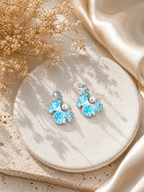 Blue and white scalloped dangle earrings with pearl accents and sparkling stud tops | SISTERHOODS-SHA256:773c651ddf36800506d08d22ce7df0d48b3a57fe705acfc3f0396fff47a3a11a