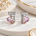 Pink faceted heart stud earrings with textured silver-tone detailing | SISTERHOODS-SHA256:e41ac89cebf75c8ce7ddd67689d9260794a1cf00802d3a75d925bd4f387b8045