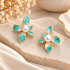 Turquoise petal-shaped flower stud earrings with white pearl-look centres and golden outlines | SISTERHOODS-SHA256:3b13e6839012f400f9388d0f2ac321a21710d855ba58e4e9d6ccd825c24c906a