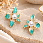 Turquoise petal-shaped flower stud earrings with white pearl-look centres and golden outlines | SISTERHOODS-SHA256:628b398f5e1be11bfe9fffbfeb0baa43cde555855c290d371c79ad1422b3dbad