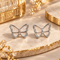 Pale pink butterfly stud earrings with sparkling silver-tone borders | SISTERHOODS-SHA256:7be70c849b43943ef0de6d88a6ce7d838b1ef7dc2c7def2fcae691e2fffcf957